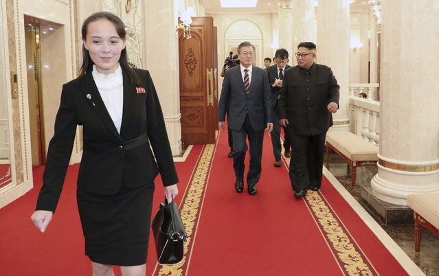 With Kim Yo Jong, left, sister of North Korean Leader, South Korean President Moon Jae-in and North Koran leader Kim Jong Un, right, arrive at the headquarters of the Central Committee of the Workers' Party in Pyongyang, North Korea, Tuesday, September 18, 2018. (Pyongyang Press Corps Pool via AP Photo)