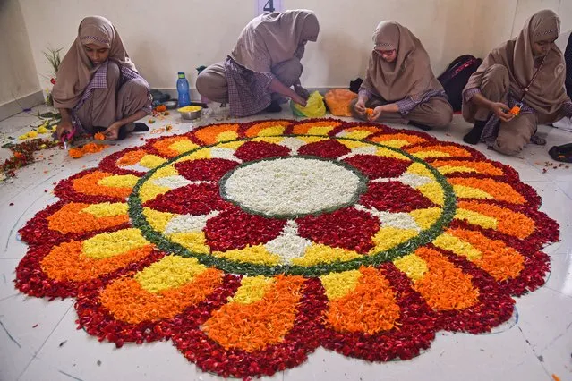 Indian Muslim students decorate a flower carpet or 'Pookalam' during a flower carpet competition as part of the Onam festival celebrations in Chennai, India, 24 August 2023. The Onam festival is a 10-day long harvest festival and is celebrated mostly in India's southern state of Kerala. Malayalam people in India and across the world put decorated flower beds in front of their houses to welcome King Mahabali, a past ruler of Kerala in southern India. (Photo by Idrees Mohammed/EPA)