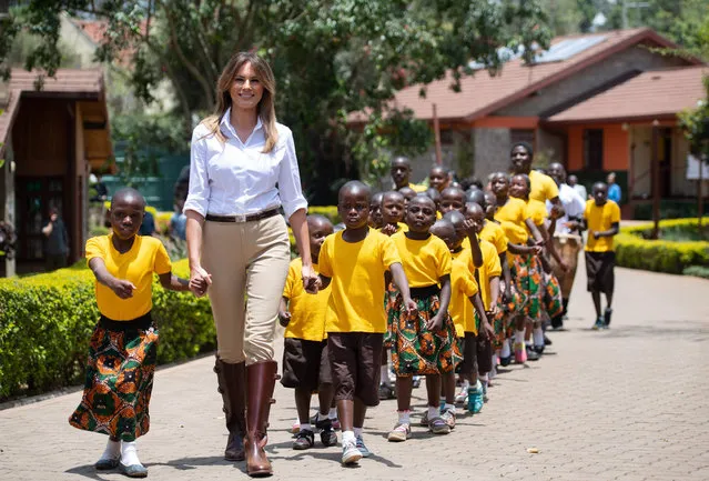US First Lady Melania Trump walks with children as she visits the Nest Childrens Home Orphanage, which primarily cares for children who' s parents have been incarcerated, in Nairobi on October 5, 2018, during the third leg of a solo tour of Africa. (Photo by Saul Loeb/AFP Photo)