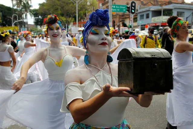 Artists perform during a protest against the government of Colombian President Iván Duque on May 26, 2021 in Medellin, Colombia. Colombians have been taking the streets since April 28, protesting against a tax reform which was then withdrew. Demands turned into a widespread expression of anger over poverty, inequality and police brutality. (Photo by Fredy Builes/Getty Images)