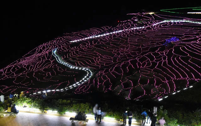 The terraced rice paddies of Shiroyone Senmaida glow under 25,000 solar-powered LED lights in Wajima, Japan on October 11, 2018. (Photo by Asahi Shimbun/The Guardian)