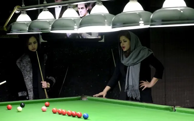 Iranian women's snooker champion Akram Mohammadi Amini (R), 26, instructs snooker during a practice session in Karaj, northwest of Tehran, Iran December 8, 2015. (Photo by Raheb Homavandi/Reuters/TIMA)