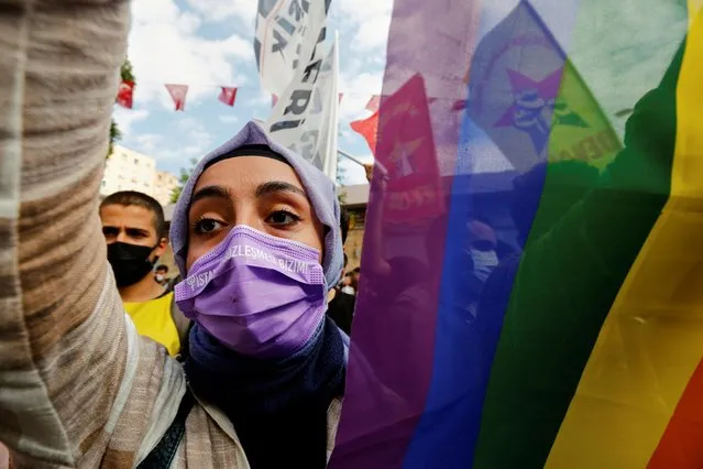 A demonstrator carries a rainbow flag during a protest against an attack on a local office of the pro-Kurdish Peoples' Democratic Party (HDP) and the killing of a woman working in the office, in Istanbul, Turkey on June 17, 2021. (Photo by Dilara Senkaya/Reuters)