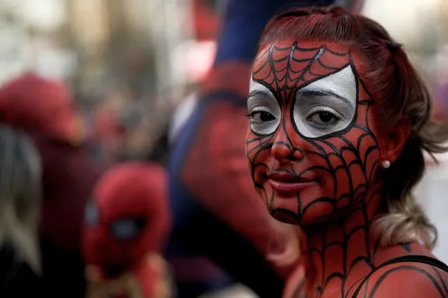 A woman painted as Spider-Man poses for a picture in Buenos Aires, Argentina, Sunday, October 29, 2023. People gathered at the Obelisk aiming to set a record for the largest assembling of individuals dressed as the comic book hero. (Photo by Rodrigo Abd/AP Photo)