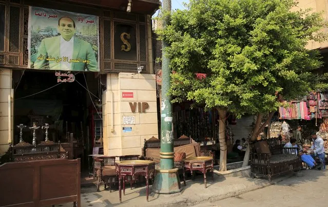 A poster of Egypt's President Abdel Fattah al-Sisi and read " Victory will coming from God" is seen at an empty coffee shop as they are wait for tourists in the Khan el-Khalili market, at al-Hussein and Al-Azhar districts in old Islamic Cairo, Egypt, November 12, 2015. (Photo by Amr Abdallah Dalsh/Reuters)