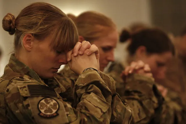 NATO troops from the International Security Assistance Force (ISAF) pray during a Christmas Eve mass at Bagram Airfield, north of Kabul, early December 25, 2013. (Photo by Mohammad Ismail/Reuters)
