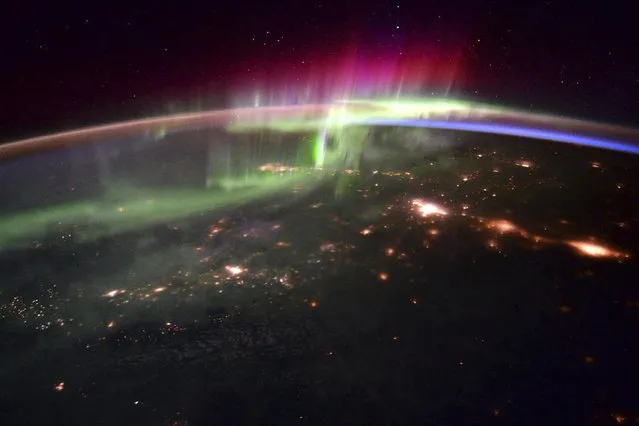 The dancing lights of the Aurora Borealis is shown over the Pacific northwest taken from the International Space Station by astronaut Scott Kelly in this handout provided by NASA, January 20, 2016. (Photo by Scott Kelly/Reuters/ESA/NASA)