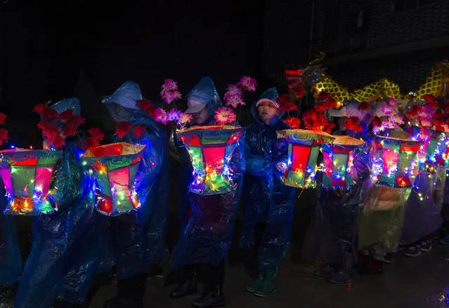 Children parade with colorful lanterns to welcome Lantern Festival on February 18, 2019 in Jiujiang, Jiangxi Province of China. People eat Tangyuan (glutinous rice balls), solve lantern riddles, watch lion dances and enjoy drum performances to celebrate the upcoming Lantern Festival, which falls on February 19 this year. (Photo by Fu Jianbin/VCG via Getty Images)