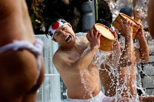 Men splash themselves with cold water during the annual cold water endurance ceremony to purify their souls and wish for good fortune in the new year, at the Kanda Myojin shrine in Tokyo, Japan, on January 13, 2024. (Photo by Kim Kyung-Hoon/Reuters)