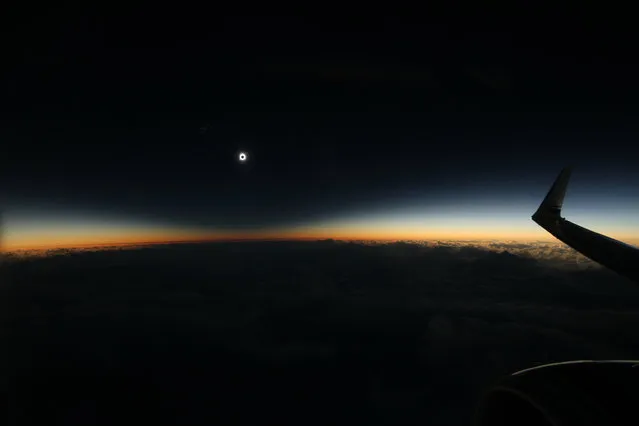 This photo provided by Dan McGlaun shows the full shadow of the moon during the total solar eclipse on Tuesday, March 8, 2016, as seen from an airplane over the North Pacific Ocean. So-called eclipse chasers boarded a special flight from Anchorage to Honolulu to view the eclipse on Tuesday from the air. (Photo by Dan McGlaun/eclipse2017.org via AP Photo)