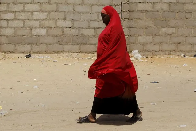 A woman walks in a camp for internally displaced people in Maiduguri, Nigeria March 9, 2016. (Photo by Afolabi Sotunde/Reuters)