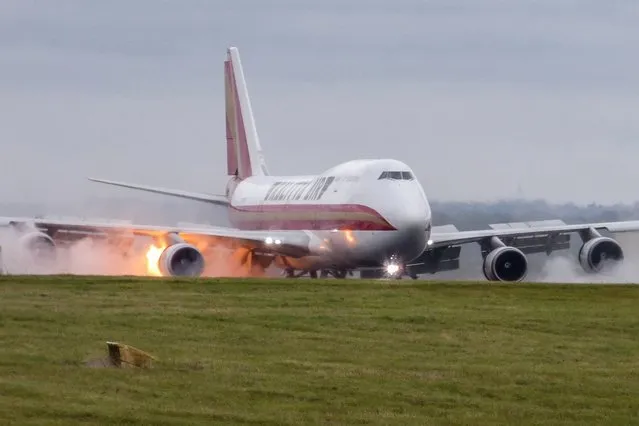 The cargo carrier burst into flames as it touched down on the tarmac at East Midlands Airport, England on September 30, 2021. No one is believed to have been injured on the cargo carrier, which arrived from Leipzig in Germany and lit up the evening sky with orange flames. (Photo by Tony Johnson/alexroebuck.co.uk)