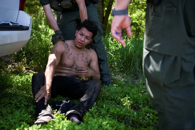 U.S. Border Patrol agents apprehend an undocumented man from Honduras after he illegally crossed the U.S.-Mexico border in Mission, Texas, U.S., April 9, 2019. (Photo by Loren Elliott/Reuters)
