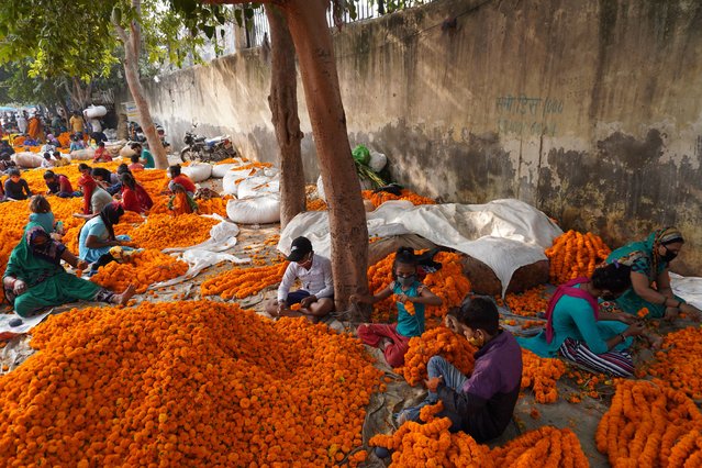 People rush to buy flowers at Ghazipur Mandi on the eve of Deepawali on November 3, 2021 in New Delhi, India. (Photo by Mayank Makhija/NurPhoto/Rex Features/Shutterstock)