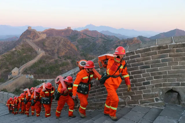 Firefighters conduct fire protection patrols on the Great Wall near Jinshan Mountain, Chengde, China on April 2, 2019. (Photo by Costfoto/Barcroft Images)
