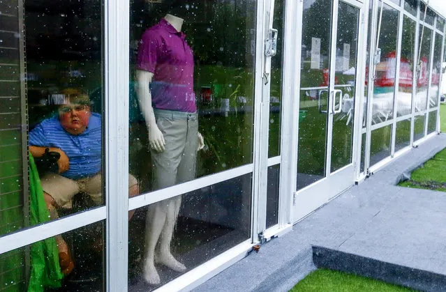Johnson Cosby, of Rainbow City, Ala., watches from the gift shop as play is suspended due to weather during the final round of the Regions Tradition Champions Tour golf tournament, Sunday, May 12, 2019, in Birmingham, Ala. (Photo by Butch Dill/AP Photo)