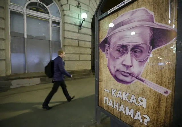 A man walks past a poster depicting Russian President Vladimir Putin and reading “Which Panama?” at a bus stop in Moscow, Russia, April 6, 2016. In Russian “panama” also means a bucket hat. (Photo by Sergei Karpukhin/Reuters)