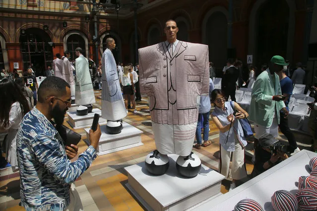 Guests take pictures of model at the Thom Browne mens Spring-Summer 2020 fashion collection presented in Paris, Saturday, June 22, 2019. (Photo by Michel Euler/AP Photo)