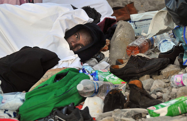 Migrants rest on the rocks by the sea in Ventimiglia, at the Italian-French border, Tuesday, June 16, 2015. Police at Italy's Mediterranean border with France on Tuesday forcibly removed a few dozen African migrants who have been camping out for days in hopes of continuing their journeys north. It was a violent scene Italy is using to show that Europe needs to do more to deal with the crisis. (Luca Zennaro/ANSA via AP)