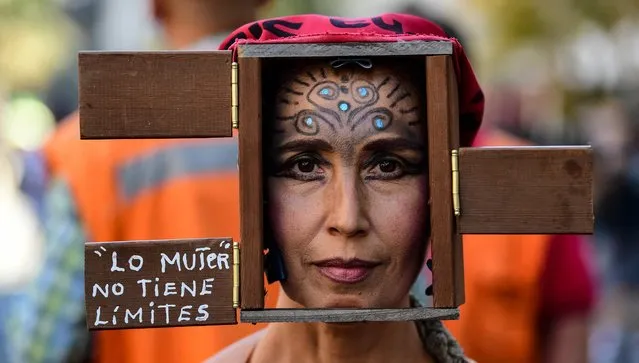 A Chilean woman pose for a picture as she takes part in a demonstration to commemorate the International Women's Day in Santiago, on March 8, 2021. Feminist organizations have called for a day of national strike to demand the end of the gender violence and to push to obtain gender equality. (Photo by Martin Bernetti/AFP Photo)