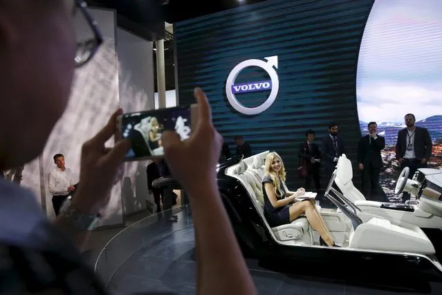 A girl types on a computer as she demonstrates the interior of the new Volvo S90 during the Auto China 2016 auto show in Beijing April 25, 2016. (Photo by Damir Sagolj/Reuters)
