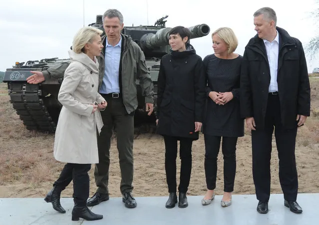 From left, German Defense Minister Ursula von der Leyen,  NATO Secretary General Jens Stoltenberg, Norwegian Defense Minister Ine Eriksen Soereide, Netherlands Defense Minister Jeanine Hennis-Plasschaert and Poland's Defense Minister Tomasz Siemoniak pose for a photo after the NATO Noble Jump exercise on a training range near Swietoszow Zagan, Poland, Thursday, June 18, 2015. (AP Photo/Alik Keplicz)