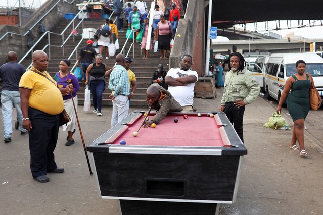 Men play pool on the sidewalk outside the Markets of Warwick in the Durban CBD, Durban, South Africa on May 31, 2024. (Photo by Alaister Russell/Reuters)