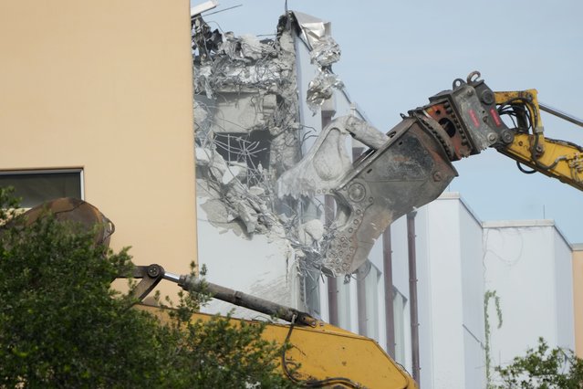 Crews start the demolition of the Marjory Stoneman Douglas High School building, Friday, June 14, 2024, where 17 people died in the 2018 mass shooting in Parkland, Fla. Officials plan to complete the weekslong project before the school's 3,300 students return in August from summer vacation. (Photo by Wilfredo Lee/AP Photo)