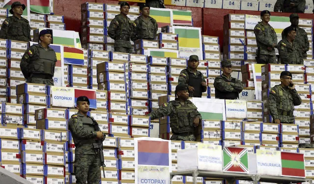 Soldiers guard marked ballots to be recounted in Quito, Ecuador, Tuesday, April 18, 2017. The National Electoral Council announced late Thursday it would recount all ballots, contested by both parties, about 10 percent of the total vote of the April 2 presidential runoff. (Photo by Dolores Ochoa/AP Photo)