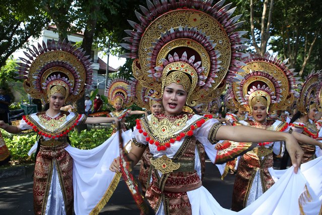 Women dancers perform during a parade at the opening of the Bali arts festival in Denpasar, Bali, Indonesia on Saturday, June 15, 2024. The Island of Bali is currently holding a month-long annual arts festival from June 15 until July 13. (Photo by Firdia Lisnawati/AP Photo)