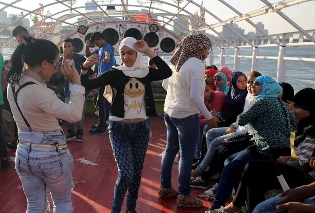 Young people dance during a Nile cruise during celebrations for Eid, which marks the end of the holy fasting month of Ramadan, in Cairo, Egypt, July17, 2015. (Photo by Asmaa Waguih/Reuters)