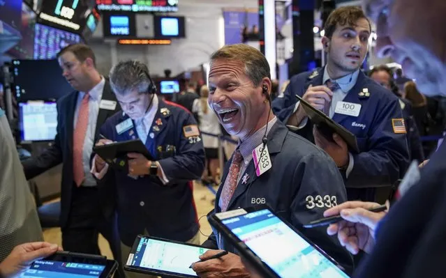 Traders and financial professionals work on the floor of the New York Stock Exchange (NYSE) at the closing bell on October 2, 2019 in New York City. The Dow Jones Industrial Average has dropped over 800 points in the first two days of trading in October. The drop comes after reports showed slowing in September for both manufacturing and hiring. (Photo by Drew Angerer/Getty Images)