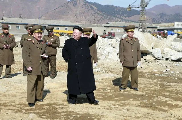 North Korean leader Kim Jong Un (C) gives field guidance to the construction site of the May 27 Fishery Station in this undated photo released by North Korea's Korean Central News Agency (KCNA) in Pyongyang March 14, 2015. (Photo by Reuters/KCNA)