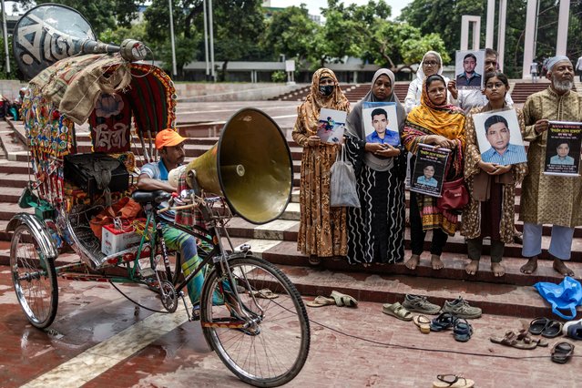 A rickshaw puller carries a speaker as family members of victims of enforced disappearance allegedly committed by government agencies during the rule of the Awami League gather holding banners and portraits of their disappeared relatives while asking for their return in front of the Shaheed Minar in Dhaka on August 11, 2024. (Photo by Luis Tato/AFP Photo)