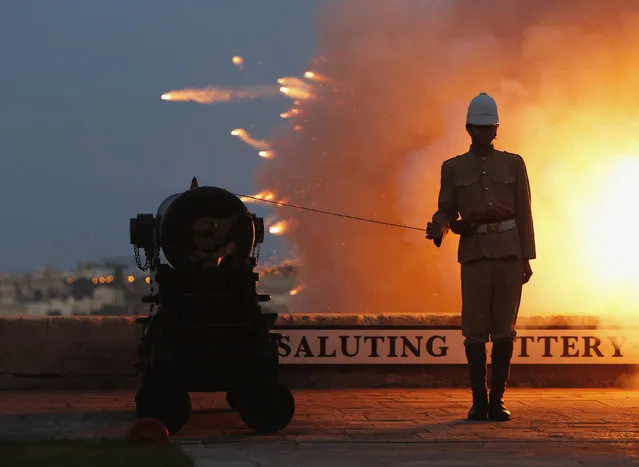 A National Heritage Trust historical re-enactor in Victorian-era Royal Malta Artillery uniform waits to fire one of several cannons during an activity to mark the feast day of Saint John the Baptist, patron saint of the Knights of the Order of Saint John, on the bastions of Valletta, June 23, 2014. The Order ruled Malta between 1530 and 1798. (Photo by Darrin Zammit/Reuters)