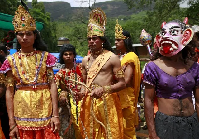 Devotees dressed as Hindu mythological characters wait to participate in a parade during “Kumbh Mela” or the Pitcher Festival in Trimbakeshwar, India, August 18, 2015. (Photo by Danish Siddiqui/Reuters)