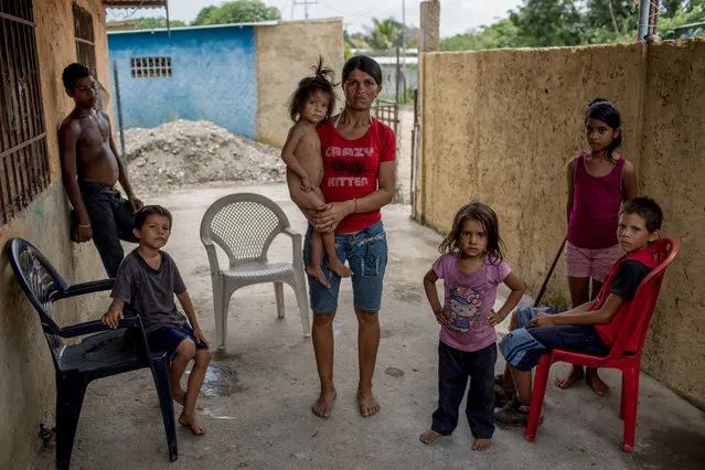 Mercedes Calderon and her kids pose for a photo in their house in Barlovento, Venezuela on June 22, 2016. The kids don't go to school because they don't have what to eat in the mornings and neither they have enough uniforms to go all at the same time. (Photo by Alejandro Cegarra/The Washington Post)