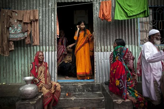 Nasoin Akhter, 15, stands in the doorway of a neighbors home on the day of her wedding to a 32-year-old man on August 20, 2015, in Manikganj, Bangladesh. (Photo by Allison Joyce/Getty Images)