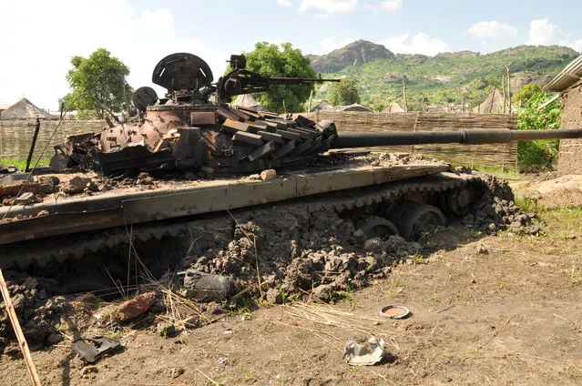The wreckage of a military tank is seen abandoned after it was destroyed in the recent fighting in the Jabel area of Juba, South Sudan, July 16, 2016. (Photo by Jok Solomun/Reuters)