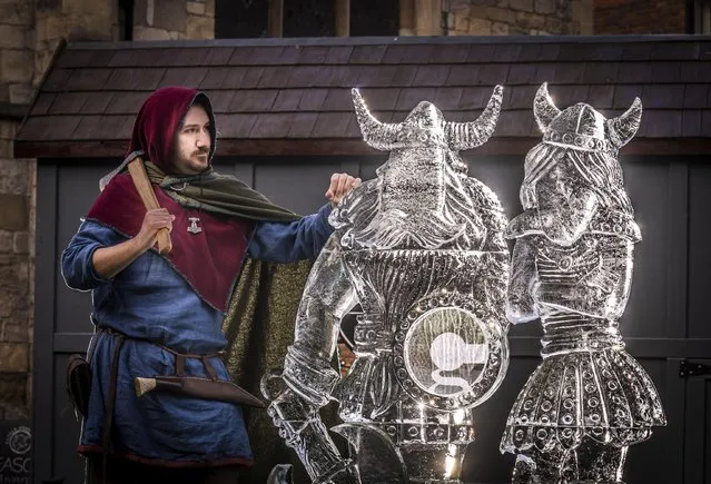 Reenactor Joshua Rowntree from the JORVIK Viking Centre, views an ice sculpture of two Vikings on Sunday, March 6, 2022, that forms part of the York Ice Trail in the York city centre, which features over 40 sculptures of solid ice. (Photo by Danny Lawson/PA Images via Getty Images)