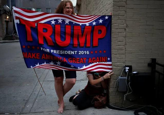 Pamela Nicolay and her 14 year-old daughter Danielle, both from Placerville, California, hold a banner in support of Donald Trump near the site of the Republican National Convention in Cleveland, Ohio, U.S., July 20, 2016. (Photo by Adrees Latif/Reuters)