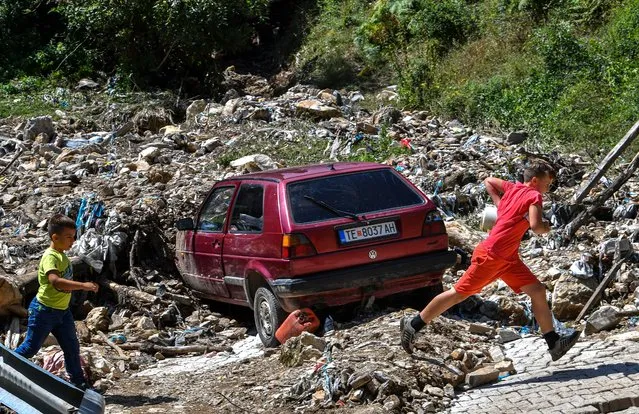 Boys run near the area affected by a landslide that hit the mountain village of Gjermo, west of Tetovo, Republic of North Macedonia, 23 August 2022. A big storm hit western part of North Macedonia on 22 August afternoon and during the night. Most damages were in the city of Tetovo and the surrounding villages. (Photo by Georgi Licovski/EPA/EFE/Rex Features/Shutterstock)