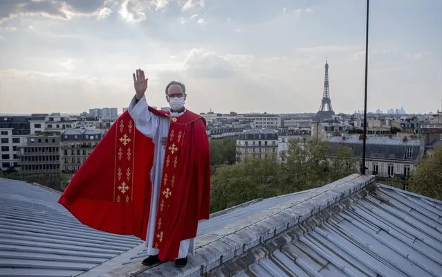 Father Bruno Lefevre Pontalis stands on the rooftop of Saint Francois Xavier church to bless the city of Paris during the national lockdown for Covid-19 at Easter, in Paris, France on April 12, 2020. (Photo by Nathan Laine/Bloomberg)