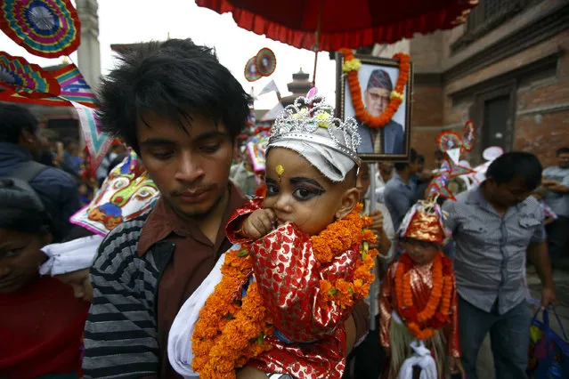 A boy dressed as Lord Krishna participates in a parade to mark the Gaijatra Festival, also known as the festival of cows, in Kathmandu August 22, 2013. (Photo by Navesh Chitrakar/Reuters)