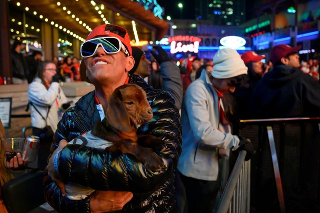 Holding a one-month old goat he brought with him, Ryan Wesley reacts to a play that went against the Kansas City Chiefs during the Super Bowl 59 watch party at the Power and Light District, Sunday, February 9, 2025, in Kansas City, Mo. (Photo by Reed Hoffmann/AP Photo)