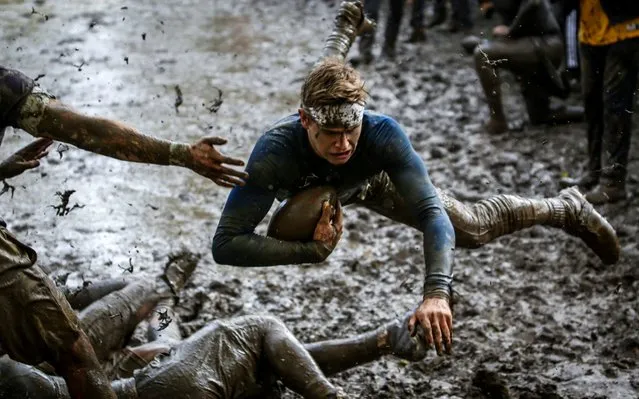 A member of Phi Delta Theta dives towards the end zone during the annual Michigan Mudbowl in Ann Arbor, Mich., on Saturday, October 28, 2017. (Photo by Hunter Dyke /The Ann Arbor News via AP Photo)