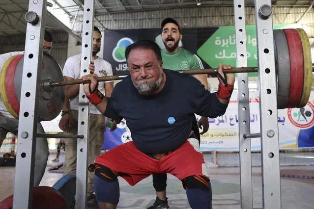 A Palestinian takes part in a Weightlifting Championship in the southern Gaza Strip town of Khan Yunis, on September 24, 2022. (Photo by Said Khatib/AFP Photo)