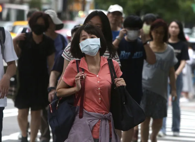 People wear face masks to protect against the spread of the coronavirus in Taipei, Taiwan, Saturday, June 6, 2020. (Photo by Chiang Ying-ying/AP Photo)