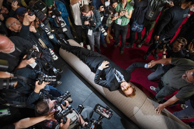 Academy Awards host Conan O'Brien lies over the red carpet during its rollout for the 97th Academy Awards in Los Angeles, California, U.S., February 26, 2025. (Photo by Carlos Barria/Reuters)