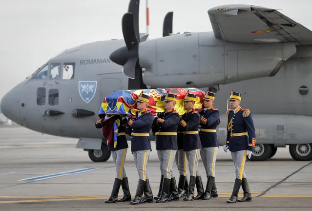 Honor guard soldiers carry the coffin of the late Romanian King Michael I at Bucharest's Henri Coanda airport, outside Bucharest, Romania, Wednesday, December 13, 2017. Former King Michael, who ruled Romania twice and was forced to abdicate by the communists in 1947, died on Dec. 5 in Switzerland at age 96. (Photo by Vadim Ghirda/AP Photo)